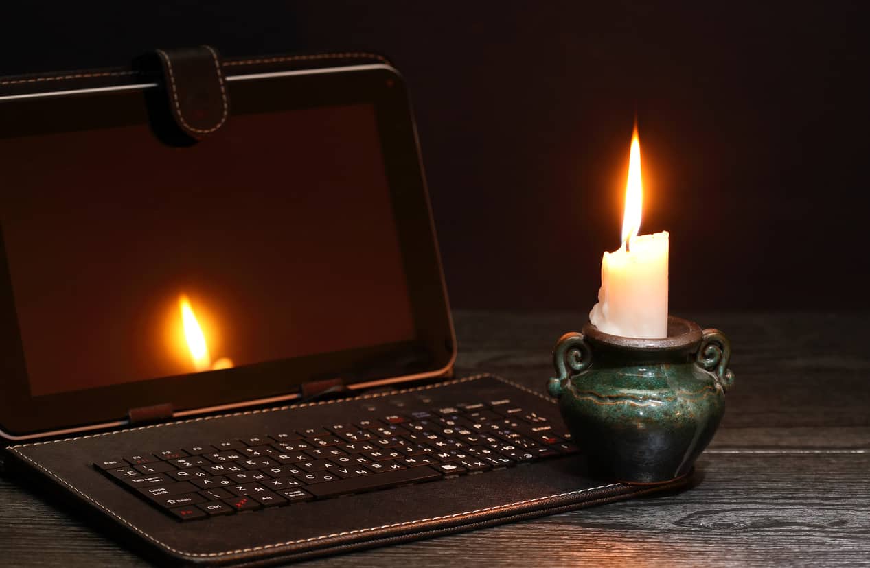 homeworking environmental impacts a laptop in candle light