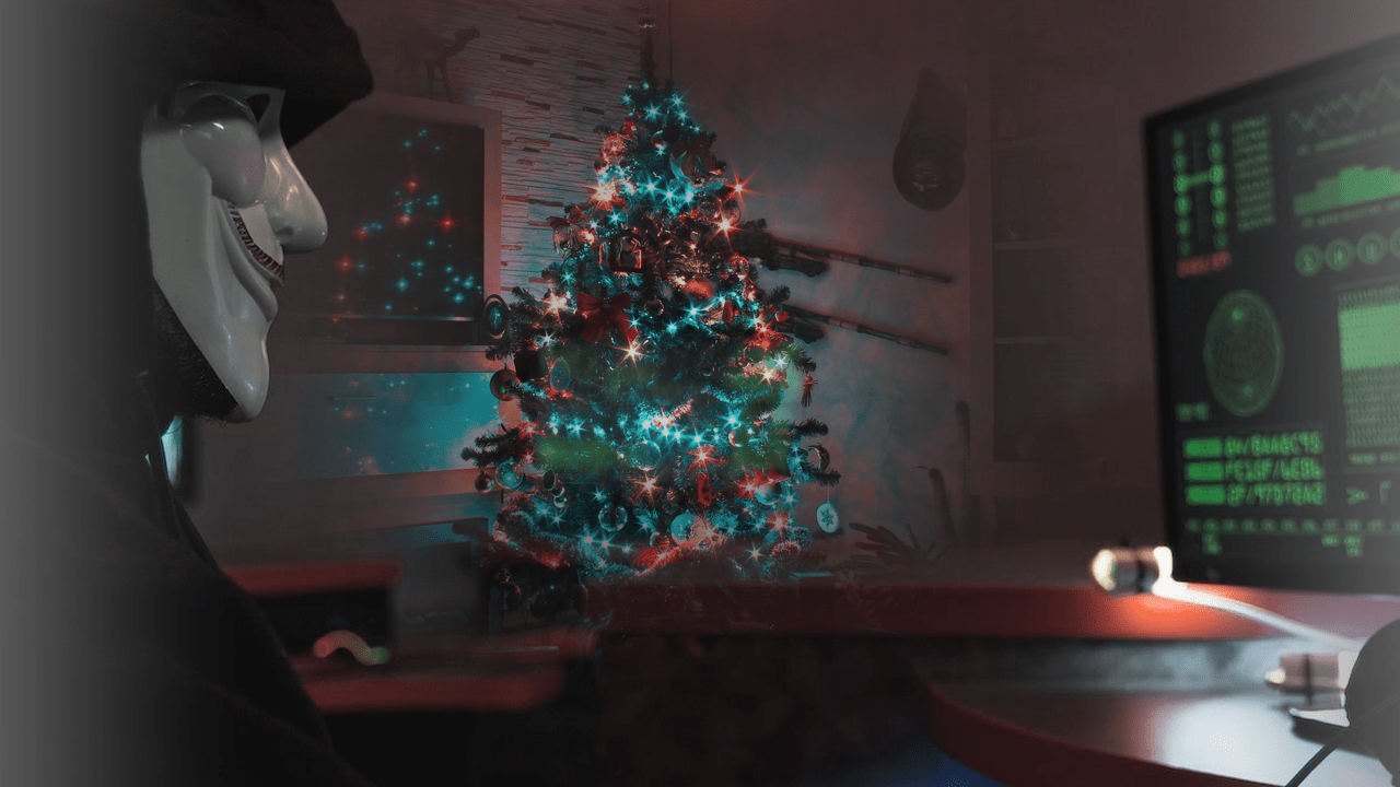 image of a hacker with a christmas tree in the background